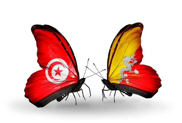 Farfalle con bandiere Tunisia e Bhutan sulle ali — Foto Stock
