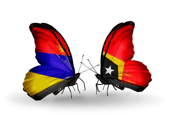 Farfalle con bandiere Armenia e Timor Est sulle ali — Foto Stock