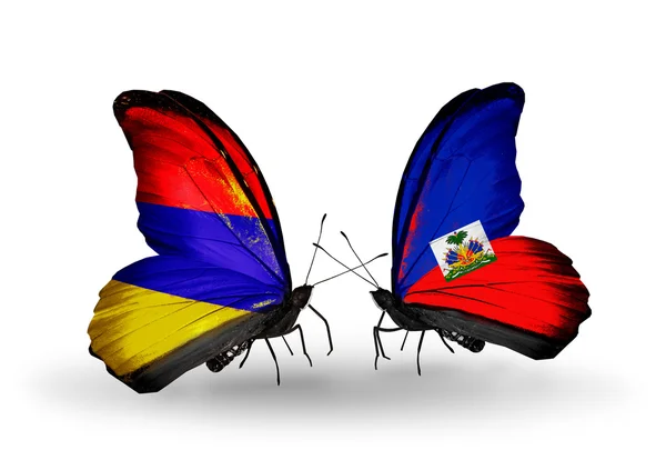 Motýli s Arménií a haiti vlajky na křídlech — Stock fotografie