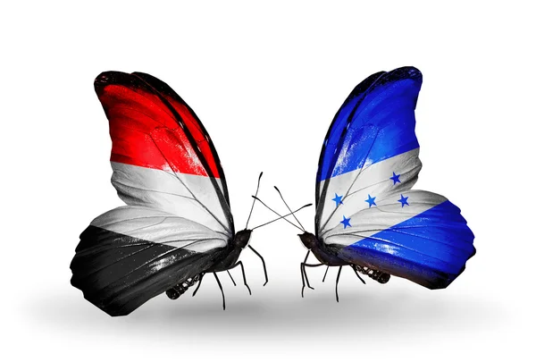 Mariposas con banderas de Yemen y Honduras en alas — Foto de Stock