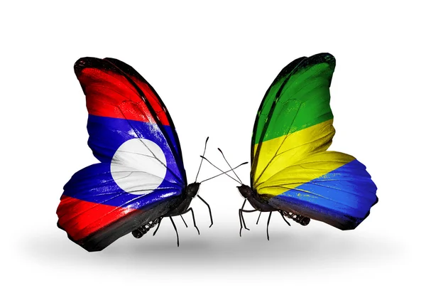 Schmetterlinge mit laotischen und gabonischen Flaggen auf Flügeln — Stockfoto
