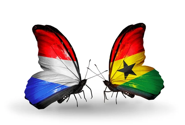 Papillons avec drapeaux du Luxembourg et du Ghana sur les ailes — Photo