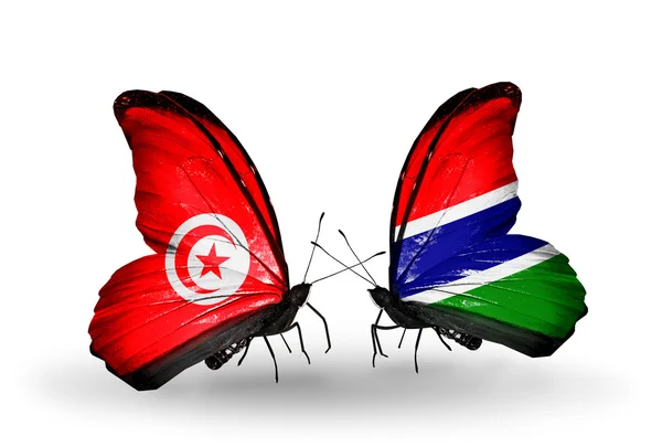 Farfalle con bandiere Tunisia e Gambia sulle ali — Foto Stock