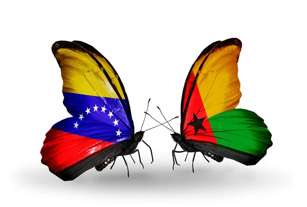 Mariposas con banderas de Venezuela y Guinea Bissau en alas —  Fotos de Stock