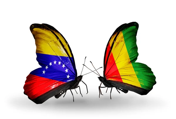 Papillons avec drapeaux du Venezuela et de Guinée sur les ailes — Photo