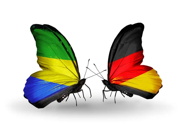 Motýli s příznaky Gabonu a Německo na křídlech — Stock fotografie
