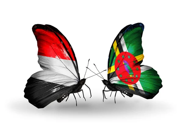 Mariposas con banderas de Yemen y Dominica en alas — Foto de Stock