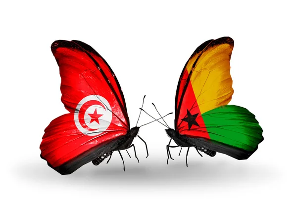 Papillons avec des drapeaux Tunisie et Guinée Bissau sur les ailes — Photo