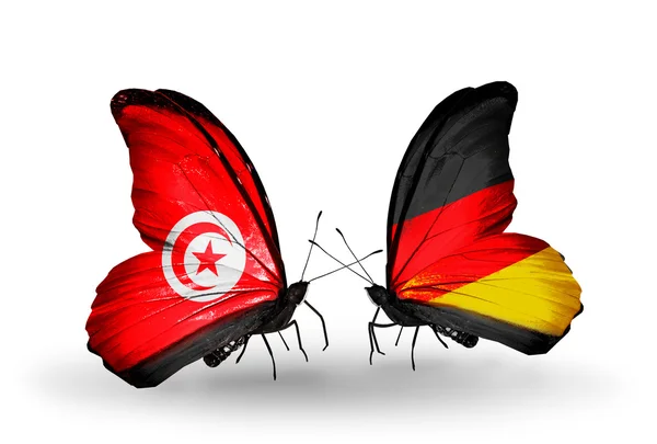 Butterflies with Tunisia and Germany flags on wings — Stock Photo, Image