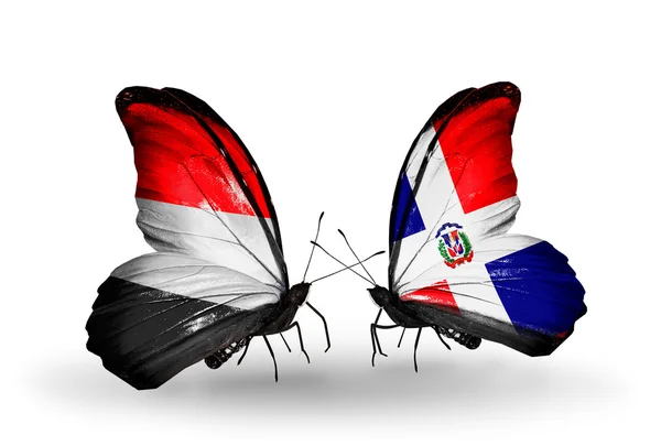 Schmetterlinge mit Jemen und Dominicana-Fahnen auf Flügeln — Stockfoto