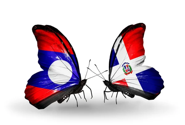 Fjärilar med laos och dominicana flaggor på vingar — Stockfoto