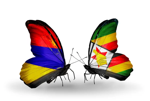 Mariposas con banderas de Armenia y Zimbabue en alas —  Fotos de Stock