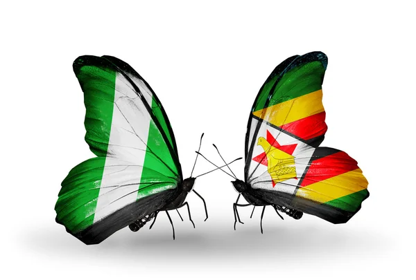 Papillons avec drapeaux Nigéria et Zimbabwe sur les ailes — Photo