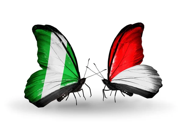 与尼日利亚和摩纳哥，印度尼西亚国旗上的翅膀的蝴蝶 — 图库照片