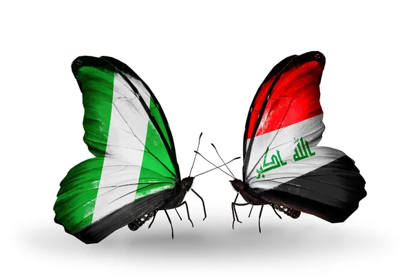 Butterflies with Nigeria and Iraq flags on wings — Stock Photo, Image