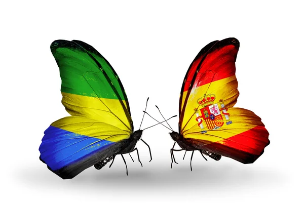 Butterflies with Gabon and Spain flags on wings — Stock Photo, Image