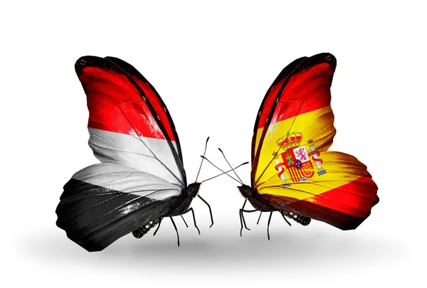 Butterflies with Yemen and  Spain flags on wings — Stock Photo, Image