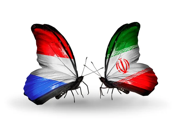 Papillons avec drapeaux Luxembourg et Iran sur les ailes — Photo