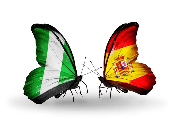 Butterflies with Nigeria and  Spain flags on wings — Stock Photo, Image