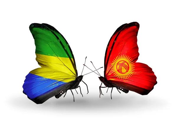 Papillons avec des drapeaux gabonais et kirghiz sur les ailes — Photo