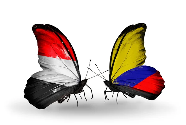 Mariposas con banderas de Yemen y Colombia en alas — Foto de Stock