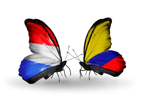 Mariposas con banderas de Luxemburgo y Colombia en alas — Foto de Stock