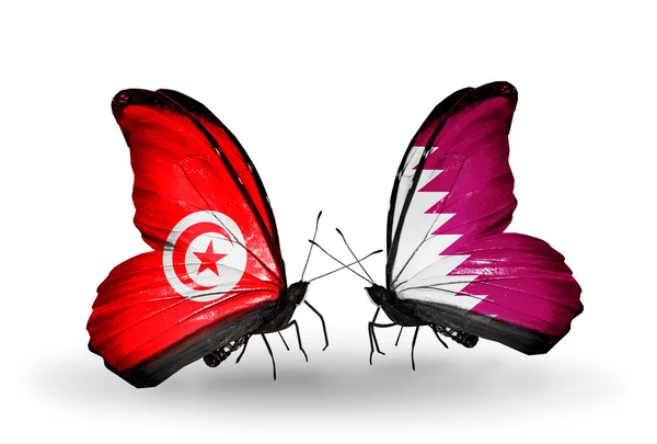 Mariposas con banderas de Túnez y Qatar en alas — Foto de Stock