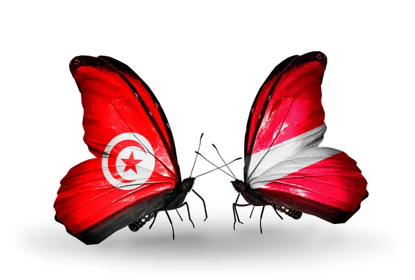 Butterflies with Tunisia and Latvia flags on wings — Stock Photo, Image