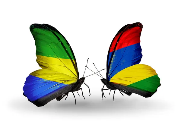 Butterflies with Gabon and Mauritius flags on wings — Stock Photo, Image