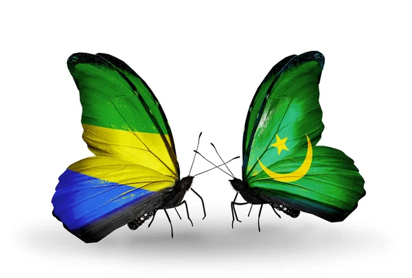 Farfalle con bandiere Gabon e Mauritania sulle ali — Foto Stock