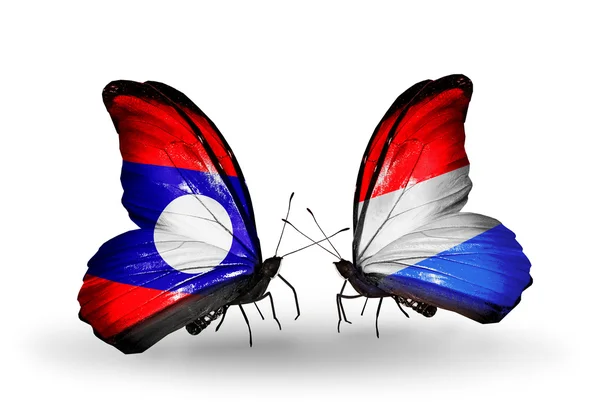 Butterflies with Laos and Luxembourg flags on wings — Stock Photo, Image