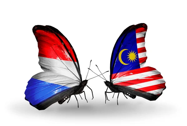 Butterflies with Luxembourg and  Malaysia flags on wings — Stock Photo, Image