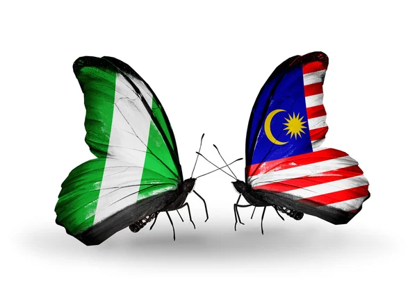 Mariposas con banderas de Nigeria y Malasia en alas — Foto de Stock