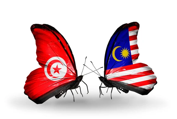 Fjärilar med Tunisien och malaysia flaggor på vingar — Stockfoto
