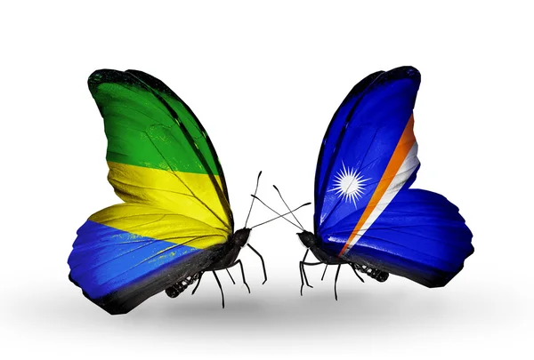 Butterflies with Gabon and Marshall islands flags on wings — Stock Photo, Image