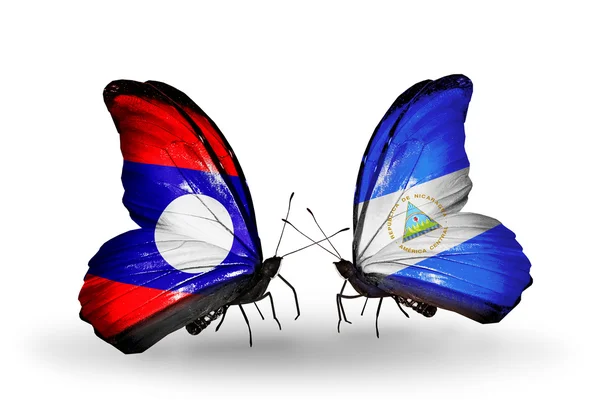 Kelebek kanatları üzerinde laos ve Nikaragua bayrağı ile — Stok fotoğraf