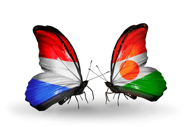 Papillons avec drapeaux du Luxembourg et du Niger sur les ailes — Photo