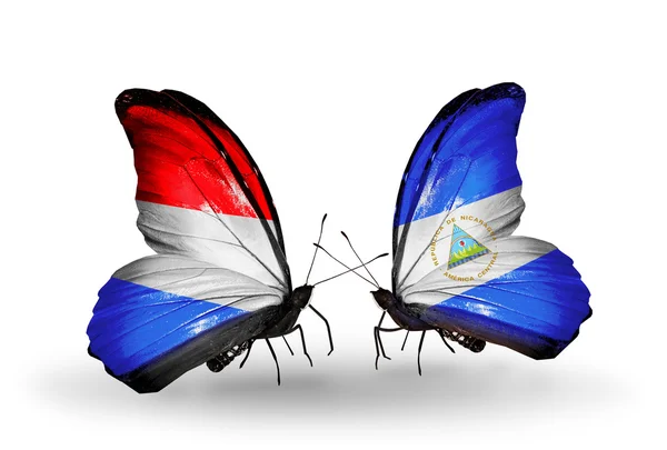 Butterflies with Luxembourg and Nicaragua flags on wings — Stock Photo, Image