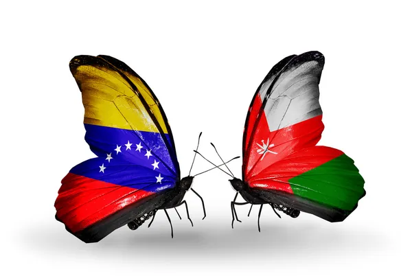 Butterflies with Venezuela and Oman flags on wings — Stock Photo, Image