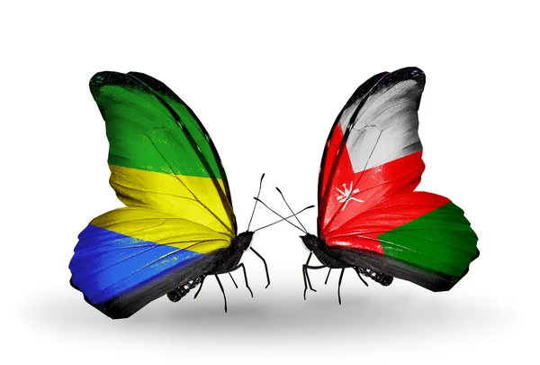 Papillons avec drapeaux Gabon et Oman sur les ailes — Photo