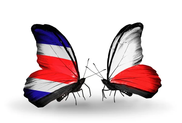Farfalle con bandiere Costa Rica e Polonia sulle ali — Foto Stock