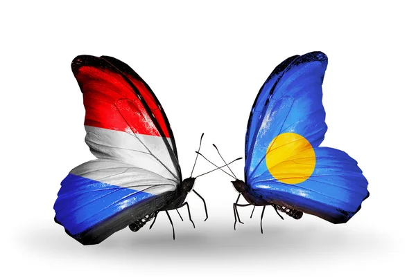 Butterflies with Luxembourg and Palau flags on wings — Stock Photo, Image