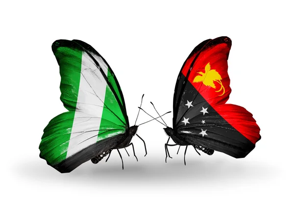 Kelebek kanatları üzerinde Nijerya ve papua Yeni Gine bayraklı — Stok fotoğraf