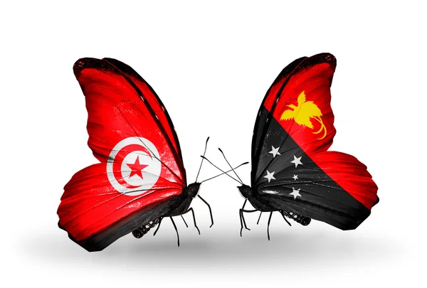 Papillons avec des drapeaux Tunisie et Papouasie-Nouvelle-Guinée sur les ailes — Photo