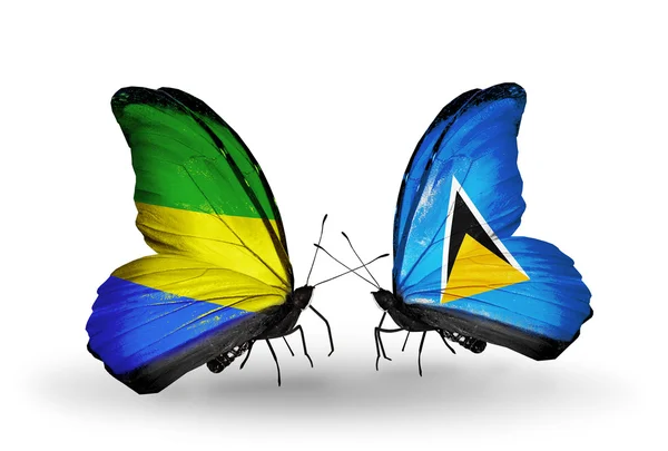 Butterflies with Gabon and Saint Lucia flags on wings — Stock Photo, Image