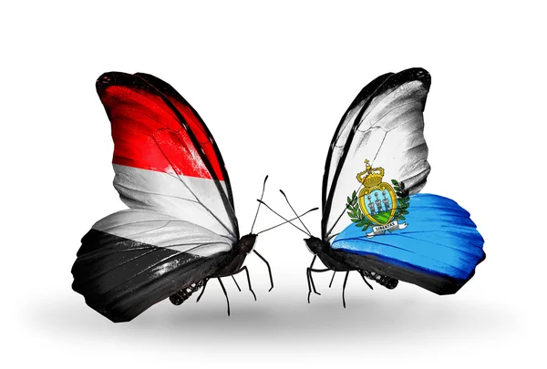 Borboletas com bandeiras do Iêmen e San Marino em asas — Fotografia de Stock