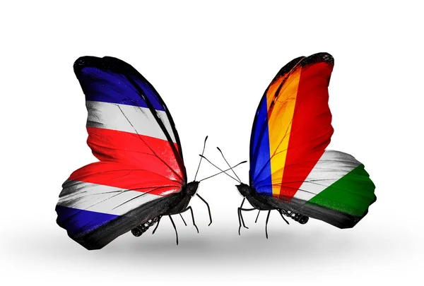 Borboletas com bandeiras da Costa Rica e Seychelles em asas — Fotografia de Stock