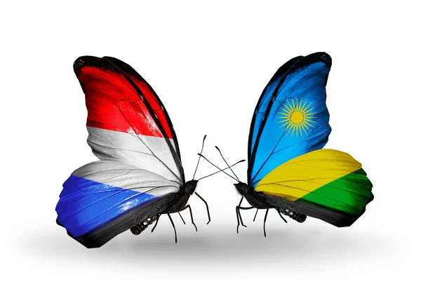 Farfalle con bandiera lussemburghese e ruandese sulle ali — Foto Stock