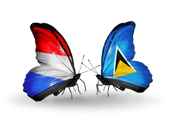 Butterflies with Luxembourg and Saint Lucia flags on wings — Stock Photo, Image