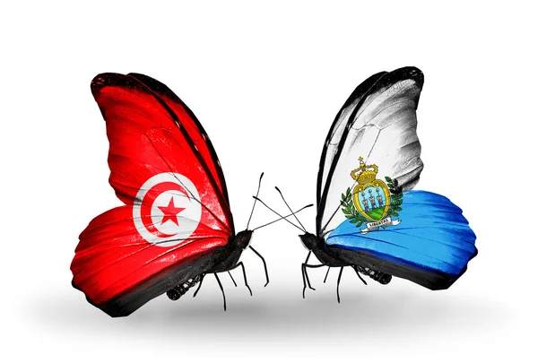 Butterflies with Tunisia and San Marino flags on wings — Stock Photo, Image